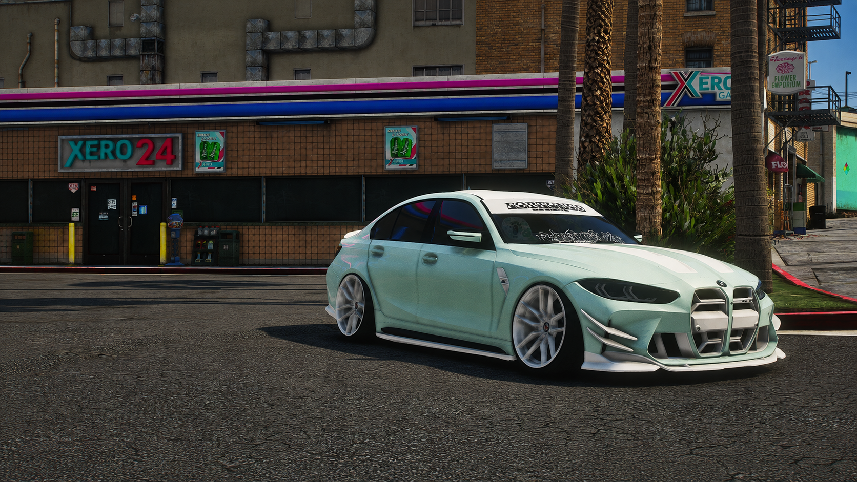 Mint-white Tsuki Factory G80 tuner car parked outside a GTA-style city petrol station